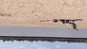 Girl laying out getting sun in a white thong bikini