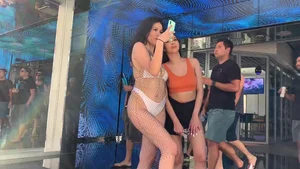 Hot chick in loose white bikini almost giving a peek of her pussy and friend with side boob