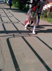 Young Candid Girl in Sneakers And Knee-Socks Walking Down the Street With a Suitcase Creepshot