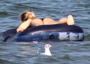 Black thong bikini blonde with a nice ass out on a tube in the water