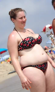 Fat chick with big boobs at the beach in a bikini