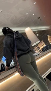 Sexy bubble butt in tight green leggings at the mall