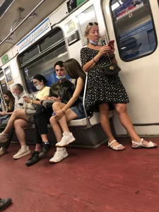 Hot Girl With Gorgeous Legs in Jean Shorts And Sneakers Sitting in a Subway Train With Crossed Legs - Touching And Swinging Her Legs