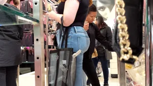 Thick redhead chick with a nice booty in tight jeans at the mall