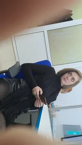 Studentgirl in a leather skirt stares intently