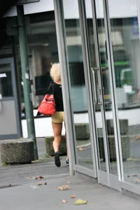 Blonde looking sexy walking in short yellow shorts