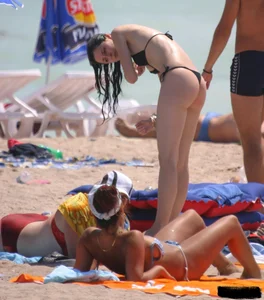 A bunch of sexy beach voyeur babes in bikinis, thongs and topless