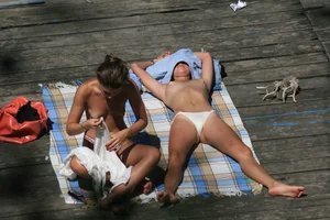 Two teens stripping and going topless to tan
