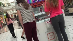 Little blonde teen in grey leggings at the mall with her friends