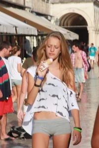 Sexy skinny blonde eating ice cream in short tight grey shorts
