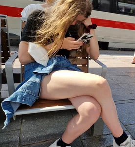 Candid Teen Girl With Awesome Legs in Shorts Sitting With Crossed Legs at the Railway Station Creepshots