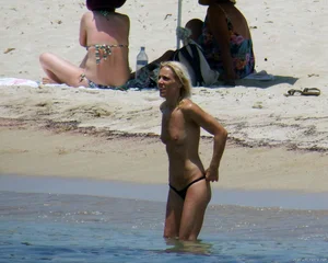Small boobed topless milf on the beach