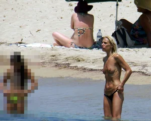 Small boobed topless milf on the beach