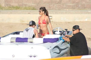 Brunette on a boat in red thong bikini with a tight little ass