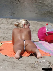 Tattooed blonde with big tits topless and in thong