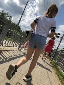Cute Girl in Denim Shorts Walking Down a Railway Station Gallery