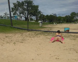 White thong brunette babe laying out on the beach with her dog