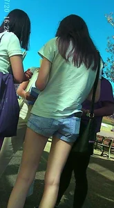 Skinny girl with purple hair in denim shorts