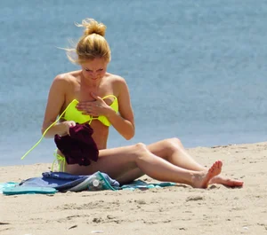 Sexy ass blonde milf on the beach in a thong with cameltoe and bending over