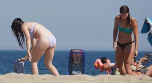 2 cute friends in bikinis on the beach