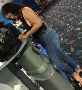 Thick brunette in tight jeans and showing some side boob