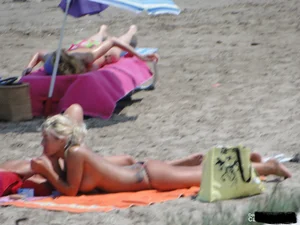 Tattooed blonde with big tits topless and in thong