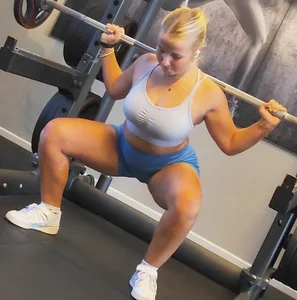 Small blonde pawg in light blue pants squatting as low as she can. Frontal view. OC