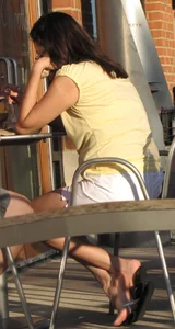 Lady in flop flops while eating showing her feet