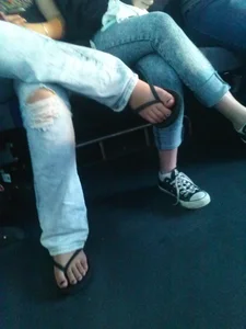 Crossed Candid Legs With Feet in Flip-Flops Closeup