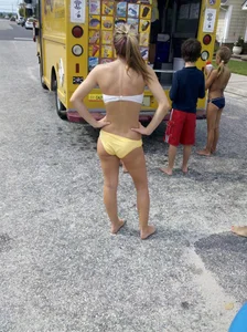 Two sexy babes in yellow bikinis at an ice cream truck
