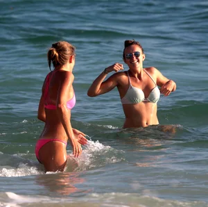 Sexy beach girl in bikini with her other sexy friend