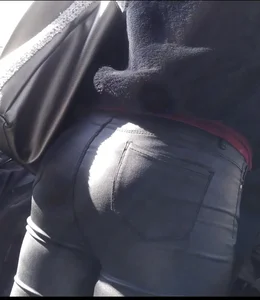 Milf shows off her shapely ass in her leather pants at the market