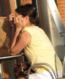 Lady in flop flops while eating showing her feet
