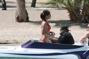 Brunette on a boat in red thong bikini with a tight little ass