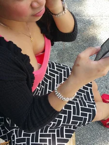 Asian chick downbloused showing nice cleavage and some bra