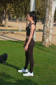 Two sexy teens playing volleyball in the park in leggings