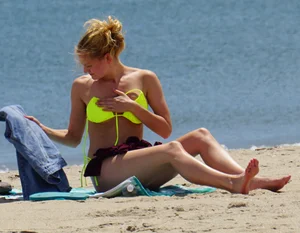 Sexy ass blonde milf on the beach in a thong with cameltoe and bending over