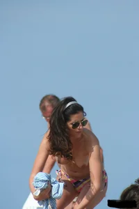 2 topless girls at the beach in thongs
