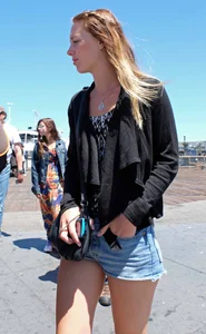 Cute girl walking in short jean shorts
