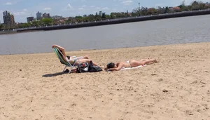 Girl laying out getting sun in a white thong bikini