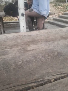 College teen in ripped pantyhose sitting outside