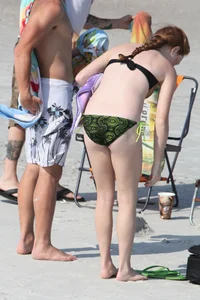 Pale redhead teen in bikini on the beach