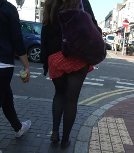 Girl in a pink skirt and stockings accidentally showing some cheek