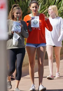 Brunette in tiny shorts walking with her sexy friend in leggings