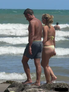 Sexy blonde on the beach in a yellow thong bikini