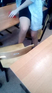 Candid Female College Student in a Skirt And Pantyhose Sitting on Top of Desk