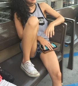 Girl in Denim Shorts Sitting on the Bench With Spread Legs Creepshot