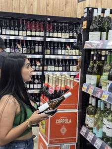 Sexy Latina buying wine