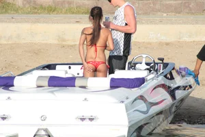 Brunette on a boat in red thong bikini with a tight little ass