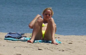 Sexy ass blonde milf on the beach in a thong with cameltoe and bending over